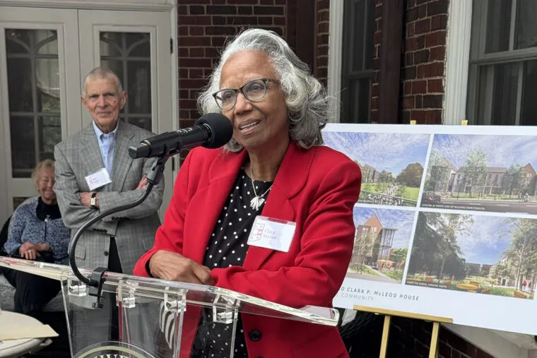 Clara Mcleod stands at a podium, speaking
