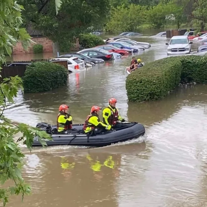 First responders use boats in north St. Louis County to help rescue residents after historic rain causes flooding. Photo by Kyler Smith.